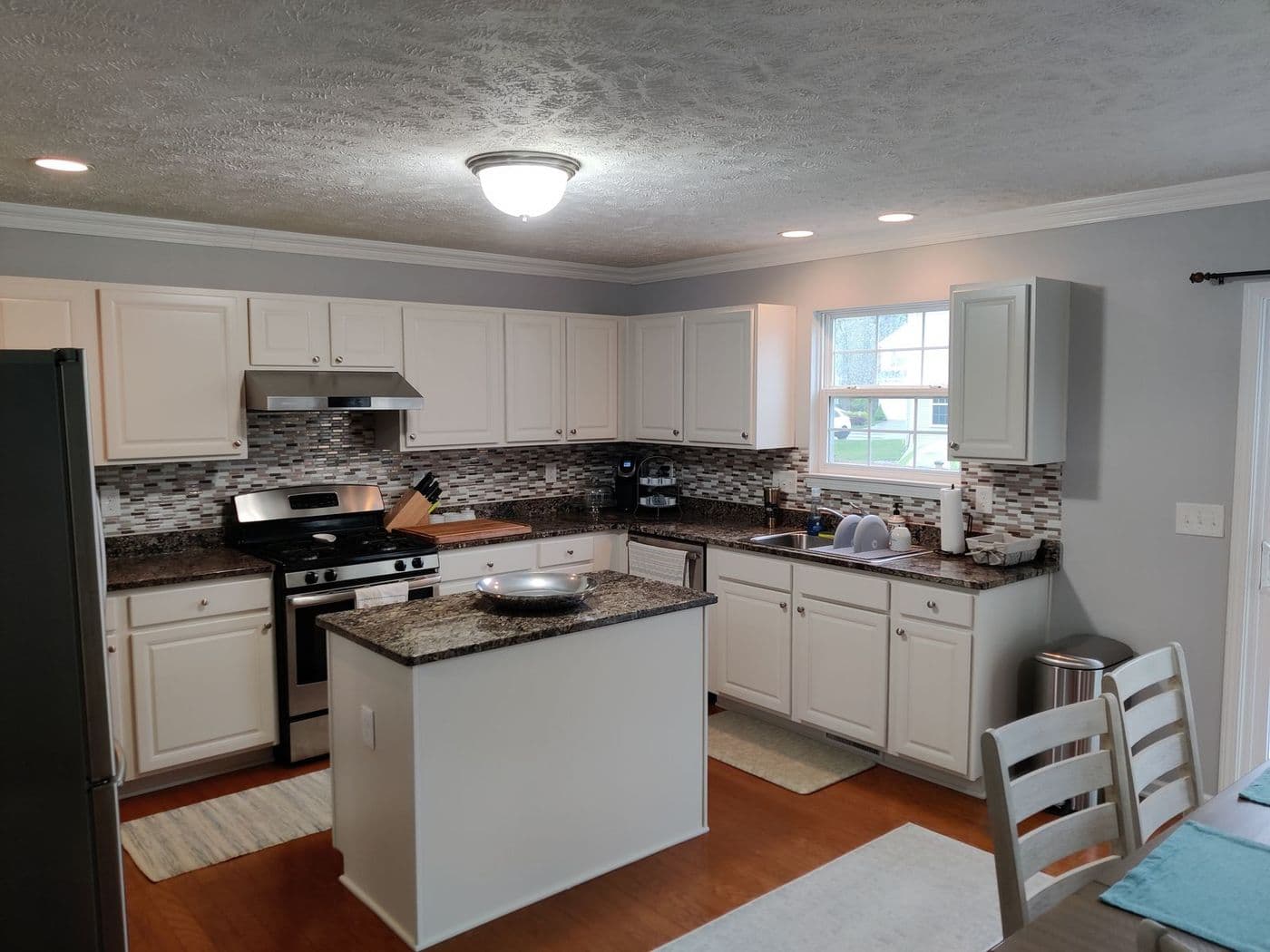 Painted kitchen cabinets with island, refinished by Cavelli Painting in Northeast Ohio