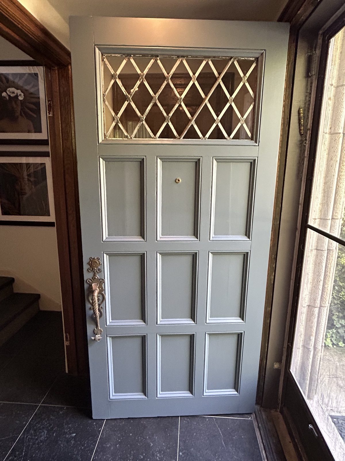 Finished antique entry door restained rich dark brown with leaded glass