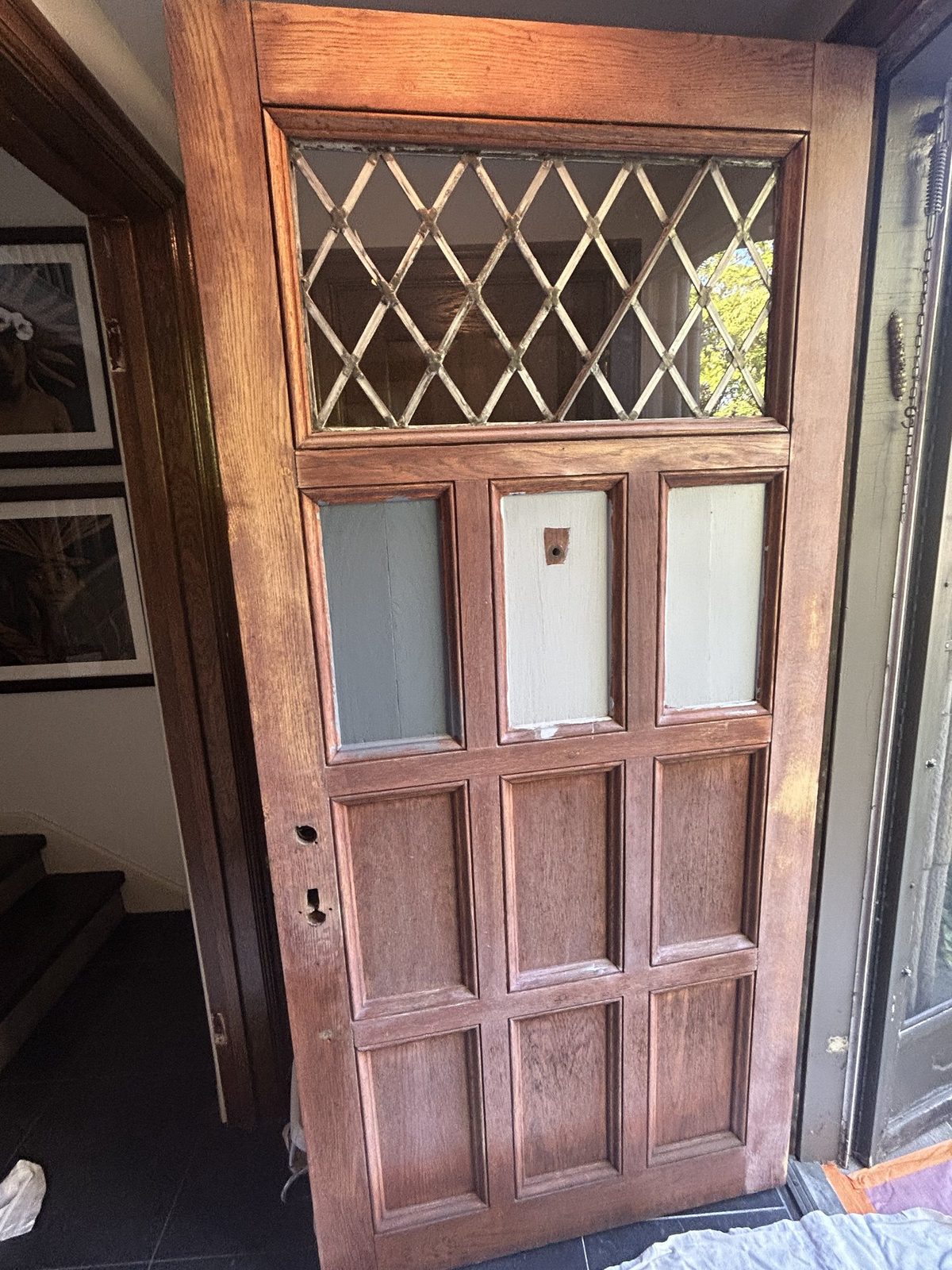 Antique wood entry door stripped to bare wood during refinishing