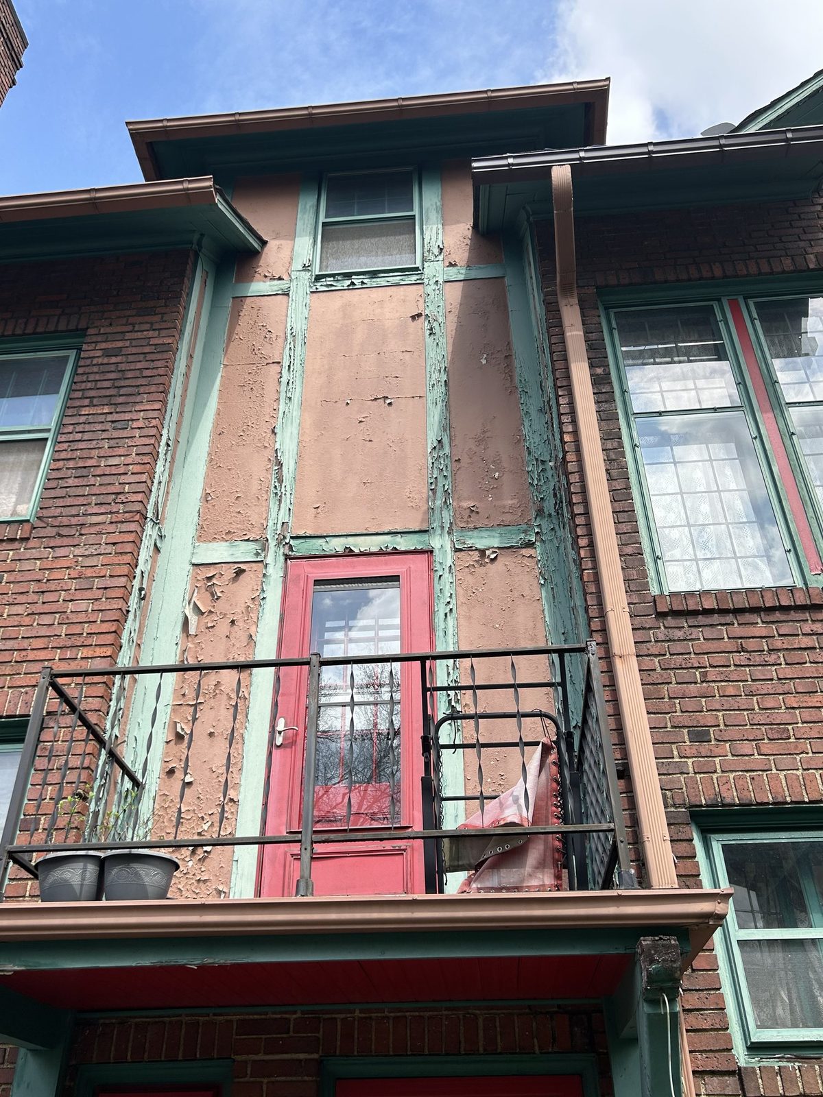 Balcony bay with peeling paint before restoration in Cleveland Heights