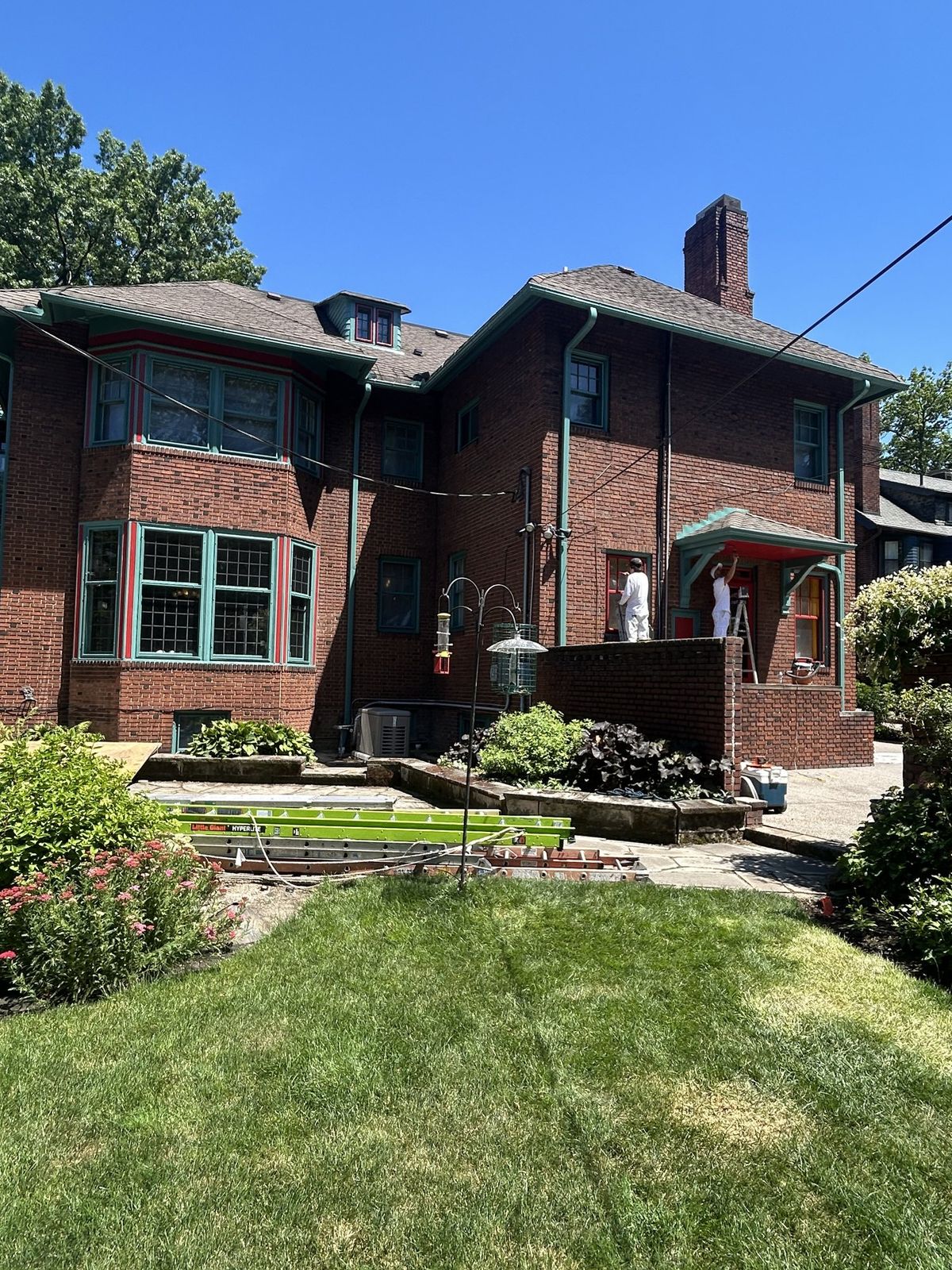 Cavelli crew prepping and painting period window trim on a Cleveland Heights brick home