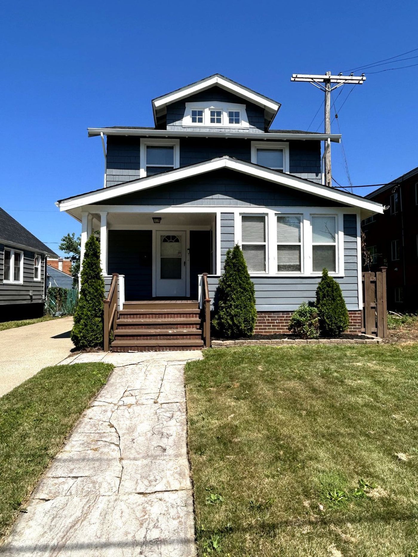 High-end exterior painting — navy blue house with crisp white trim in Cleveland, Ohio
