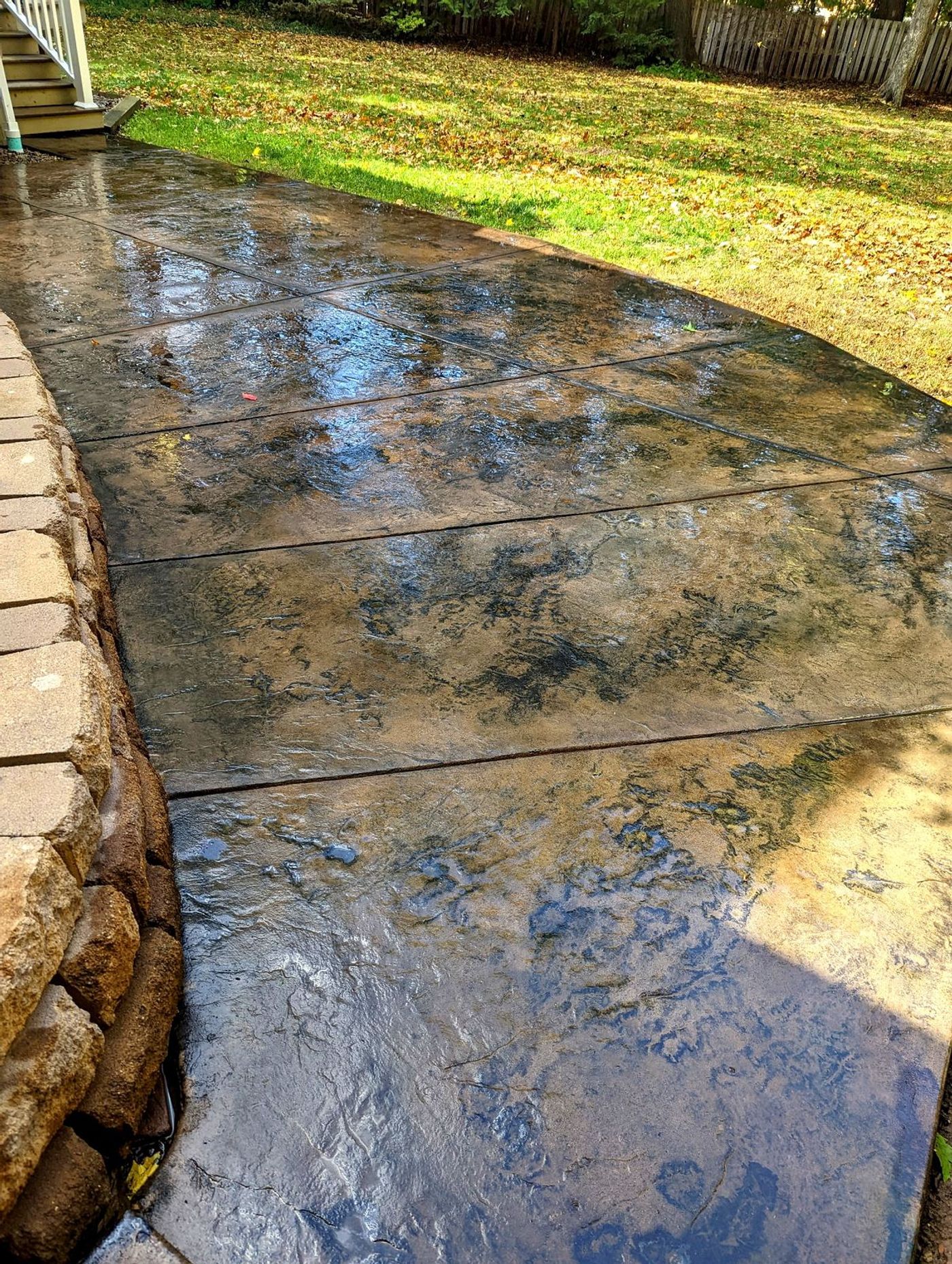 Acid-stained concrete patio walkway in rich brown tones
